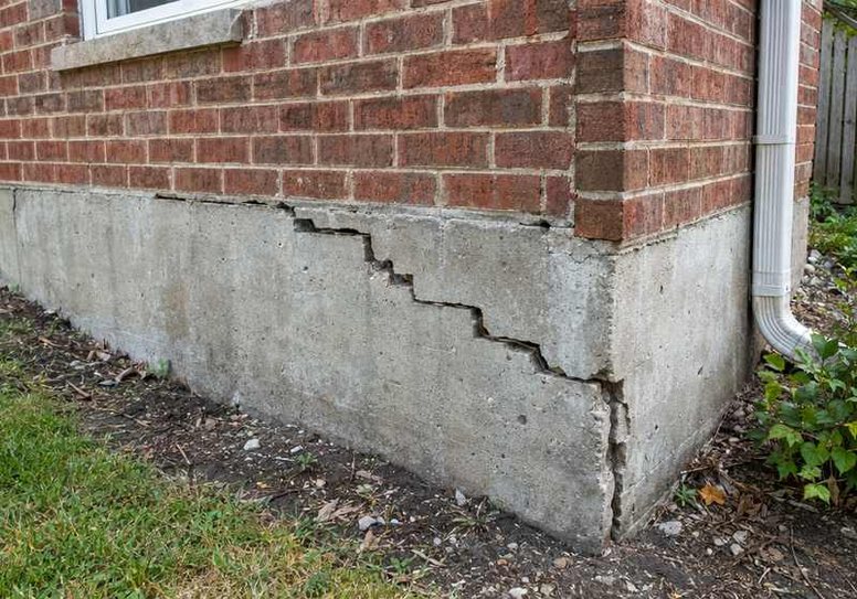 Cracked, settling foundation before repair