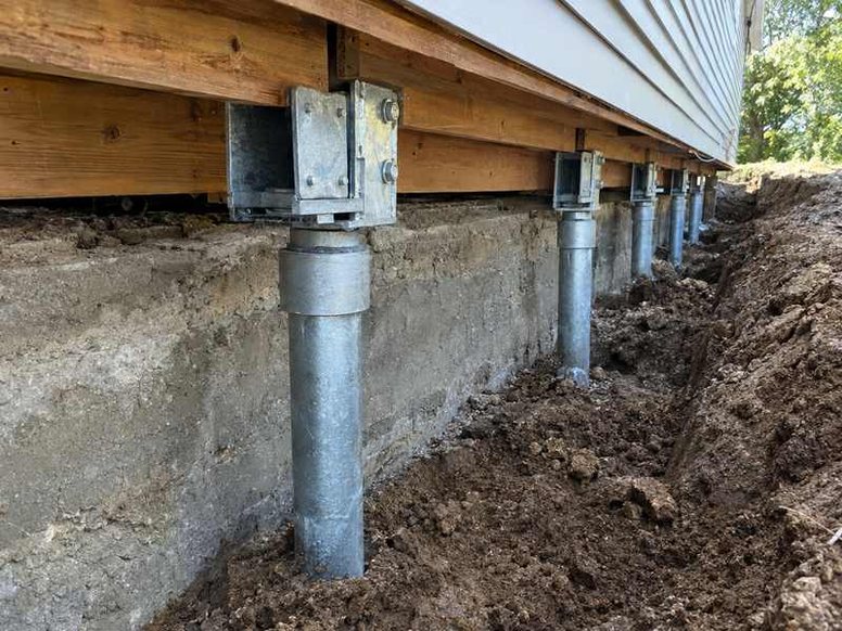 Steel piers installed to stabilize a settling home foundation in Charlotte